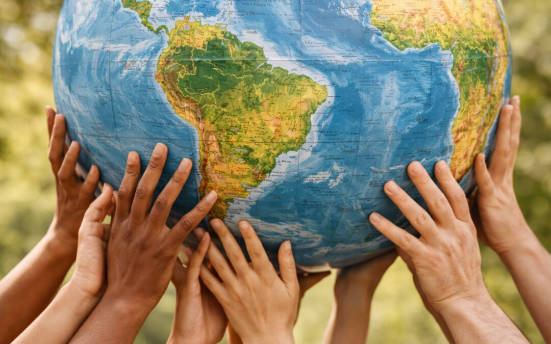 Multiple hands holding up the earth