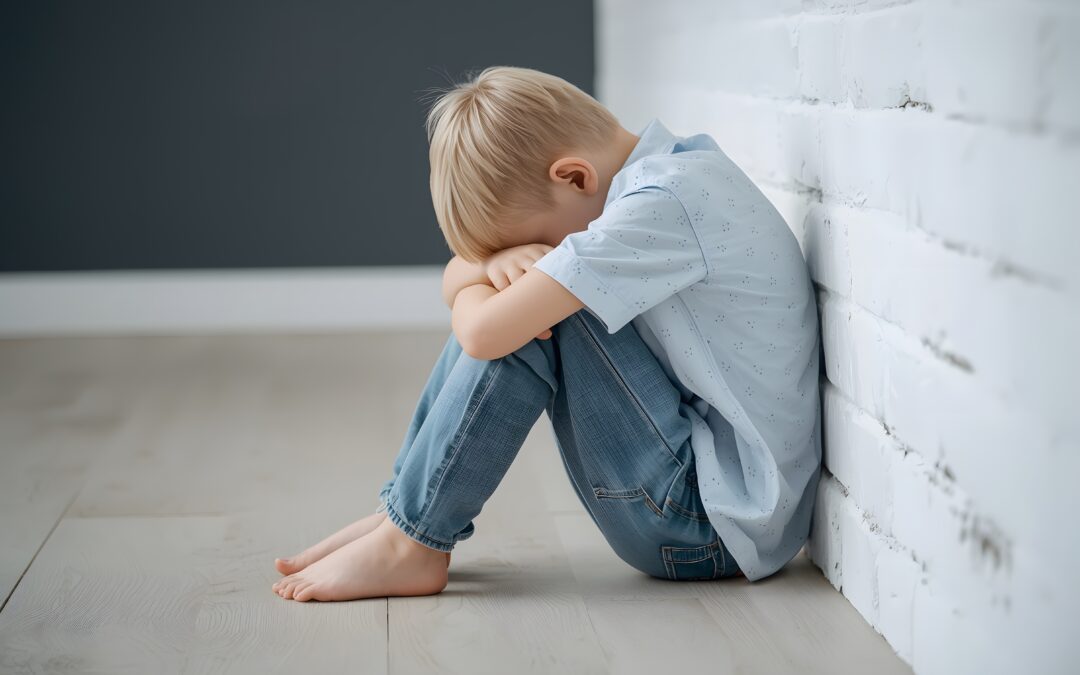 Overwhelmed child sitting by himself